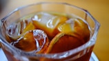 Close-up of ice cubes melting in a glass of sweet Solo tea.