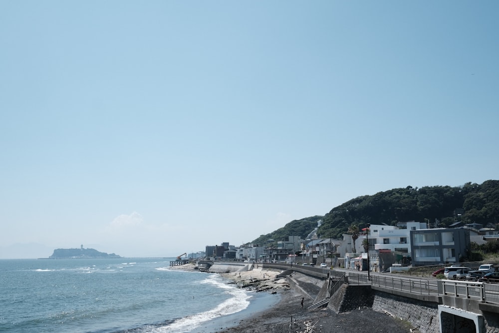 a view of a beach with houses on the shore