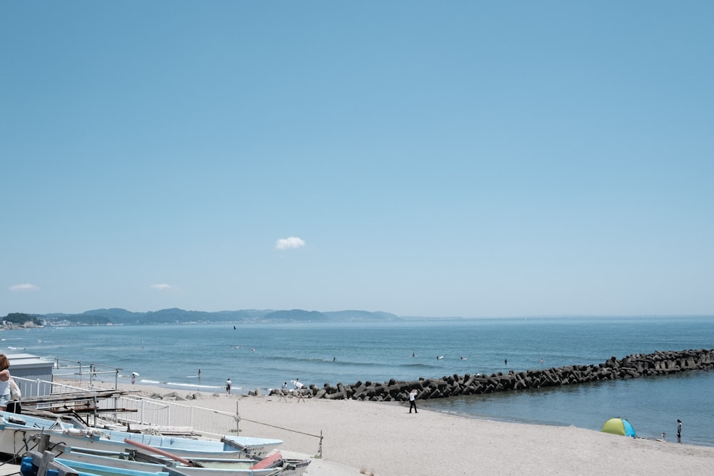 a group of boats sitting on top of a sandy beach