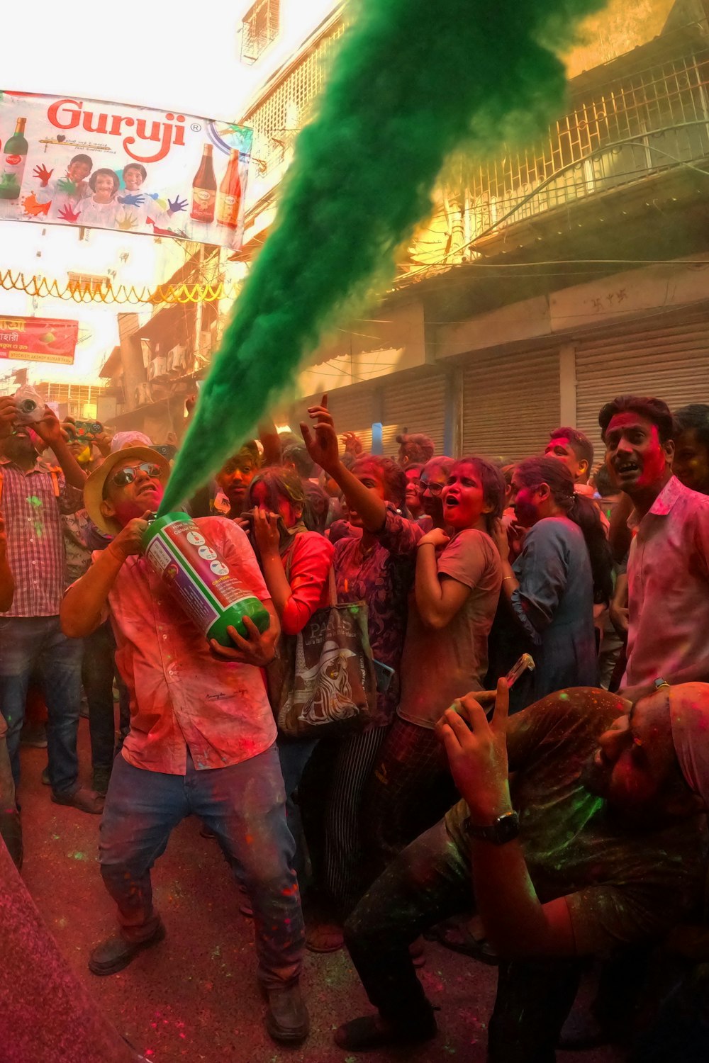 a group of people are throwing colored powder on each other