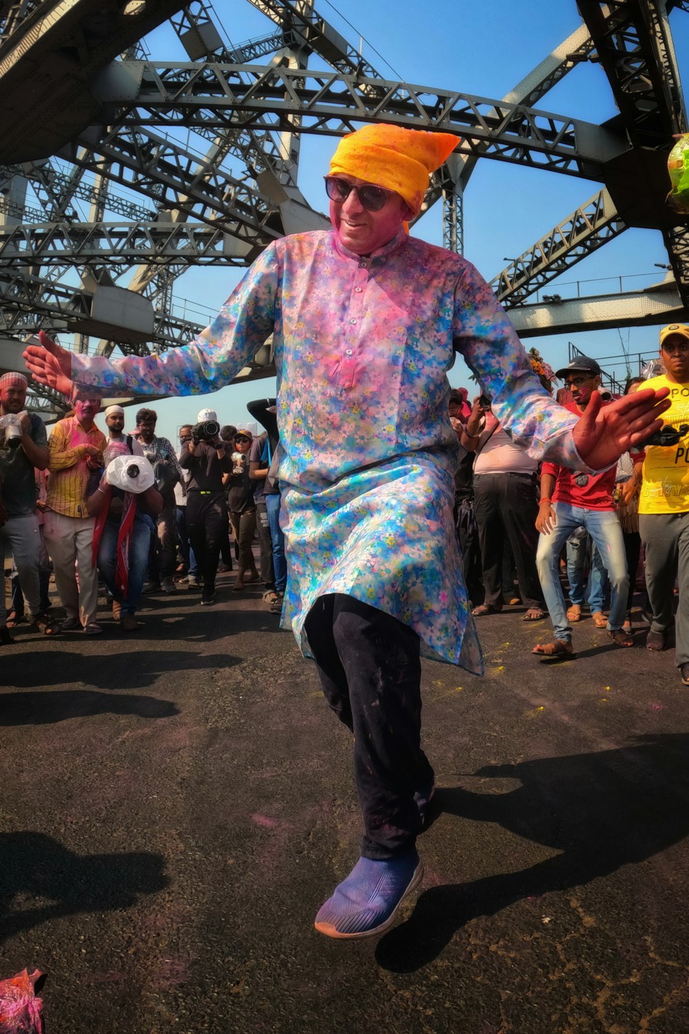 a man in a colorful outfit is dancing