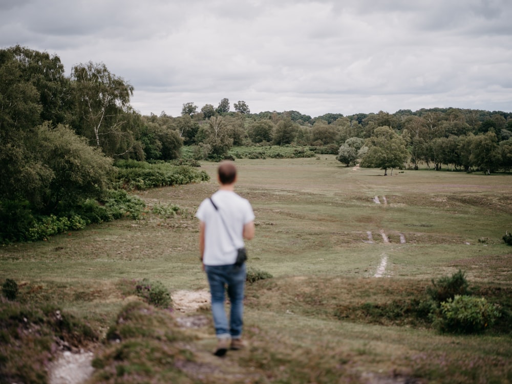 a man standing on top of a lush green field