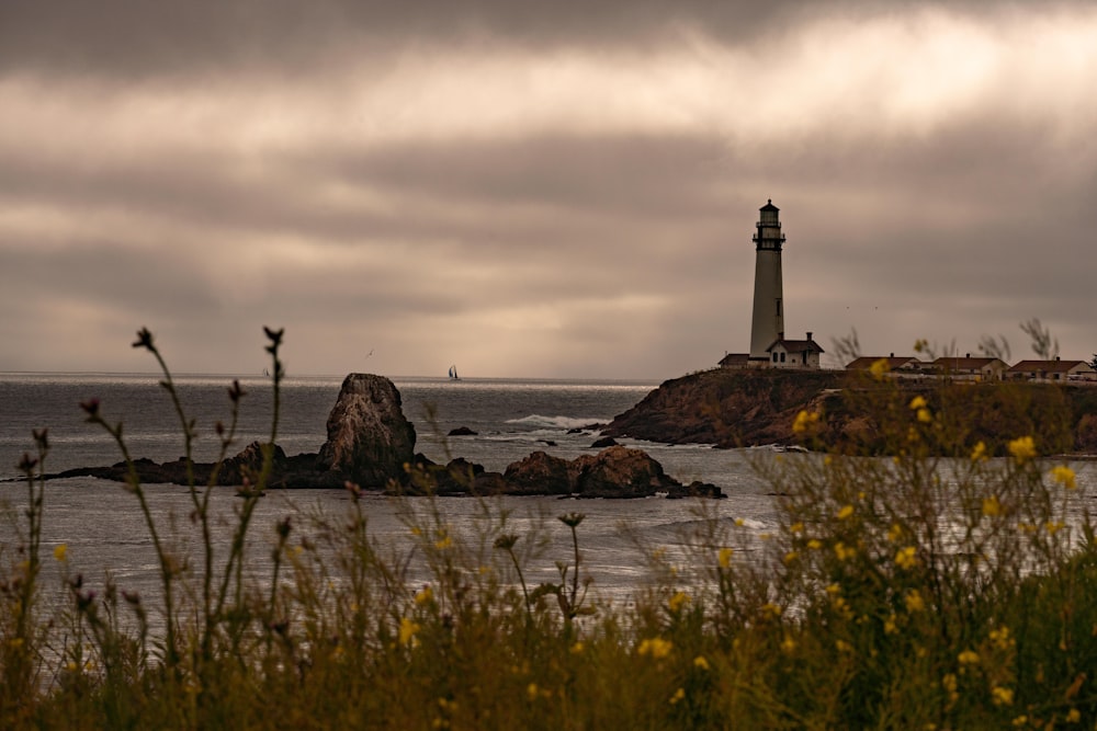 a light house sitting on top of a cliff near the ocean