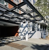 Wide shot of a commercial building entrance protected by stylish and sturdy sater shades