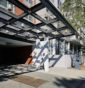 Wide shot of a commercial building entrance protected by stylish and sturdy sater shades