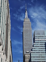 Elegant skyscraper silhouette against a clear blue sky emphasizing strategic urban growth.