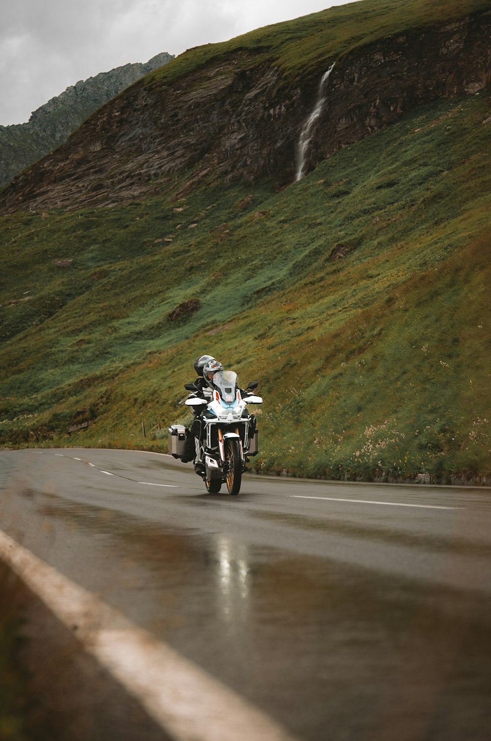 a man riding a motorcycle down a curvy road