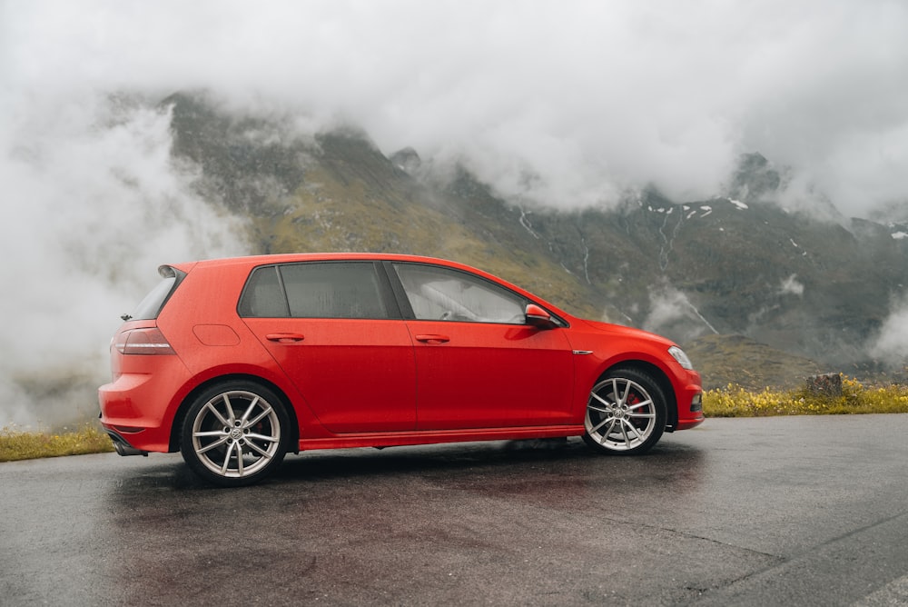 a red car parked on the side of a road