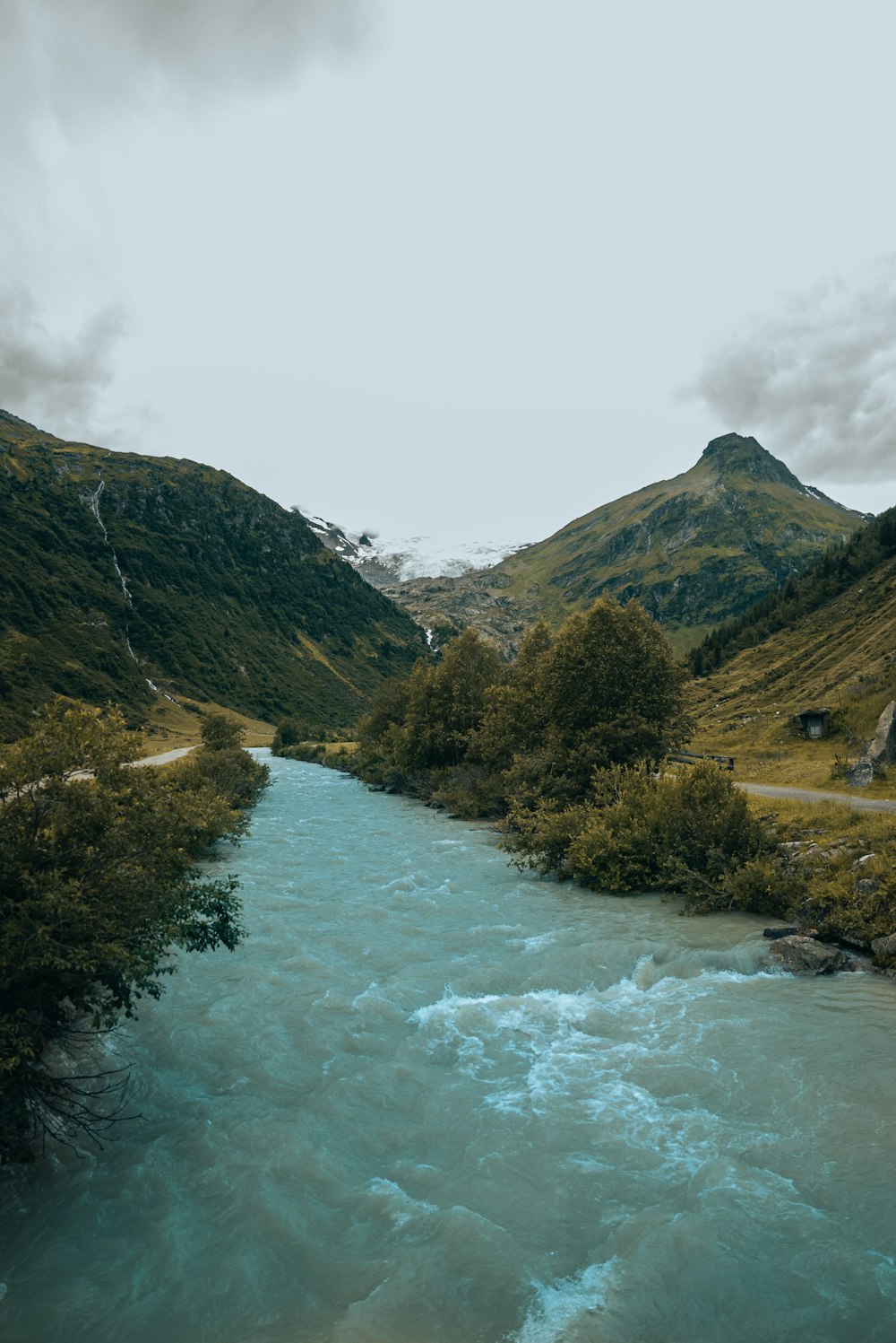 a river running through a lush green valley