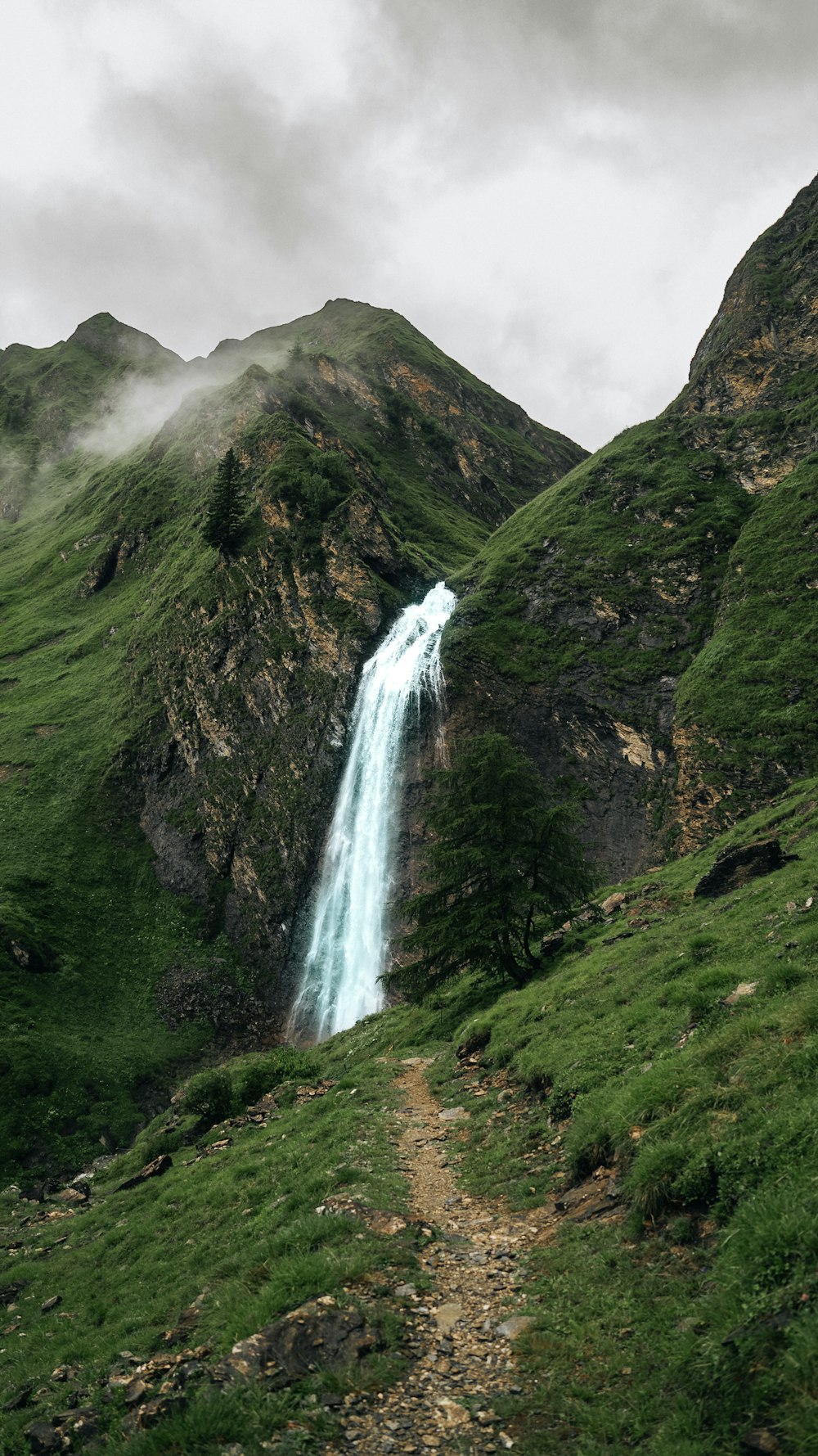 a mountain with a waterfall in the middle of it