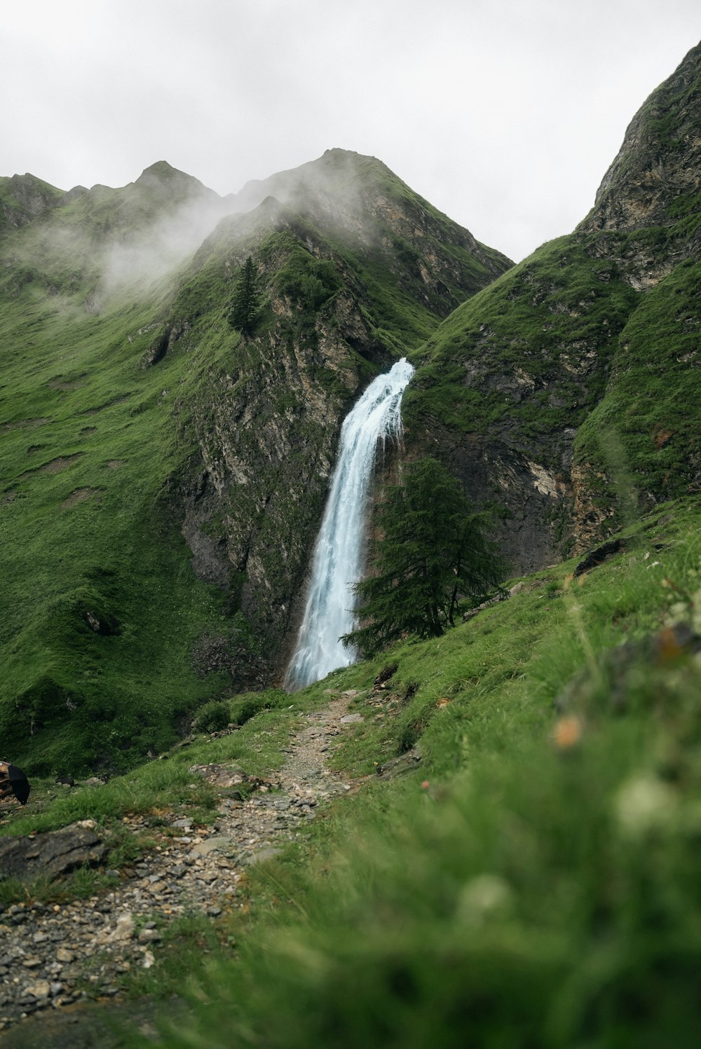 a small waterfall in the middle of a mountain