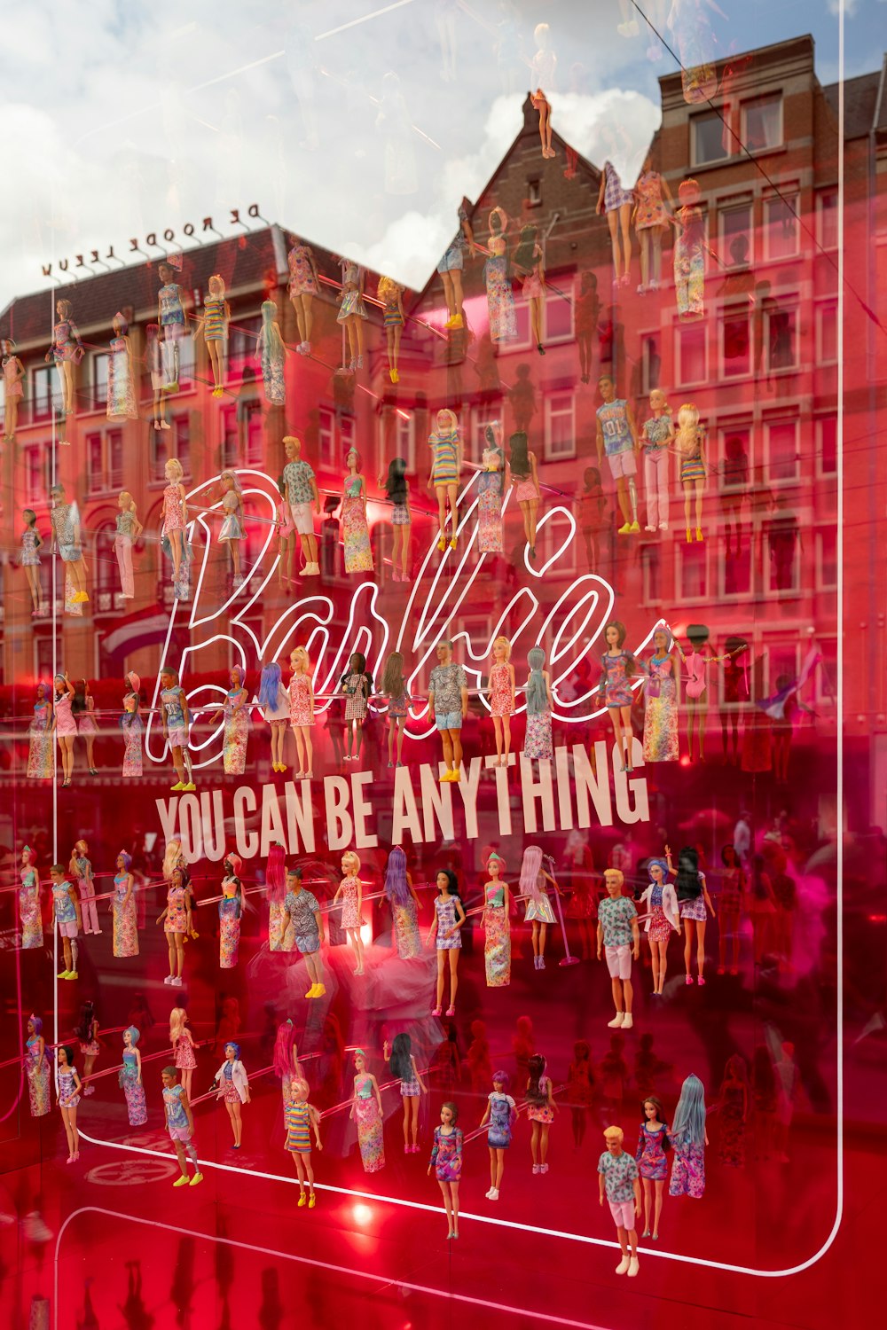 a window display of barbie dolls in a store