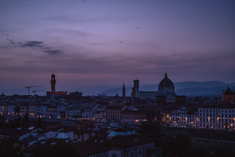 a view of a city at night from a hill