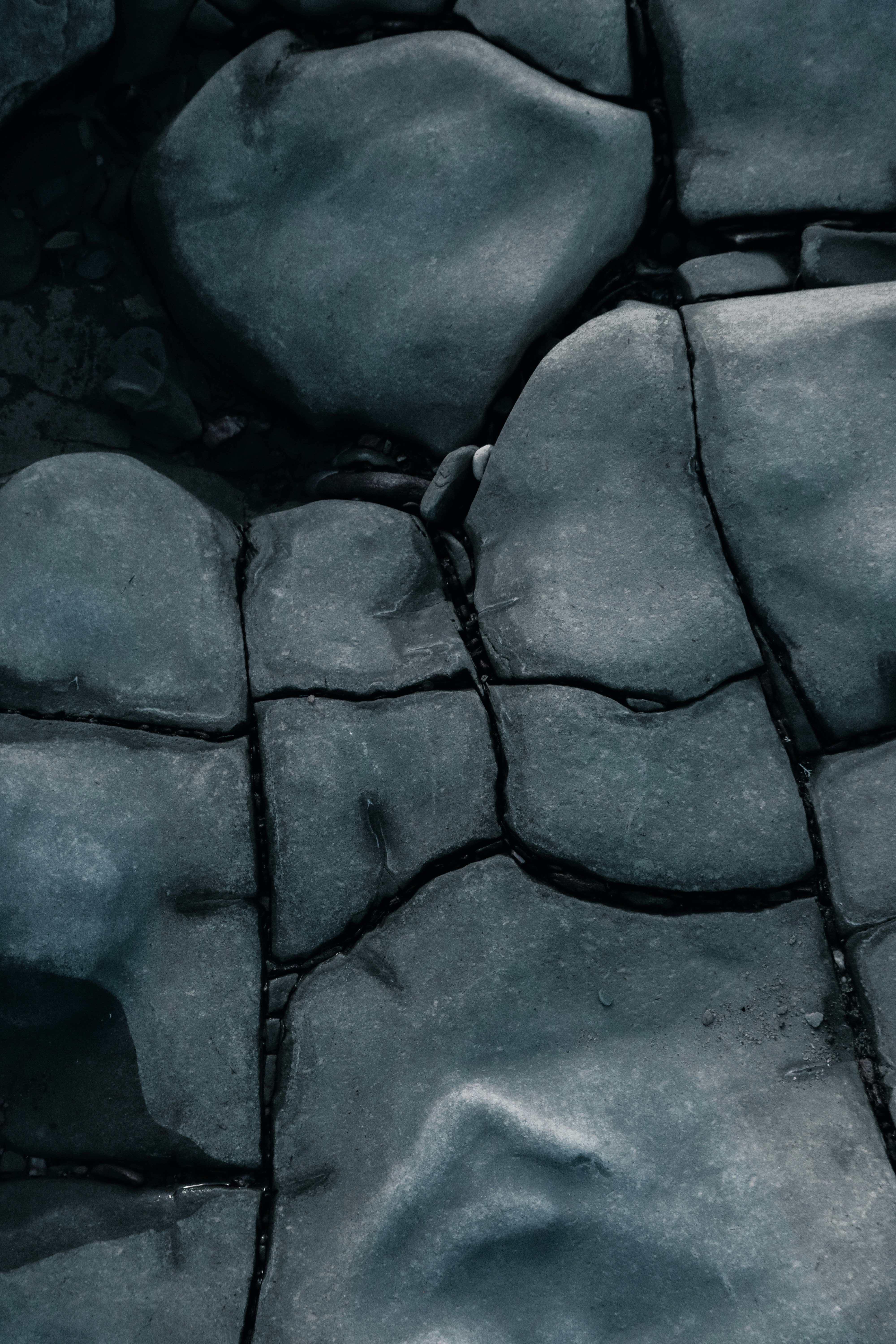 a black and white photo of rocks and water