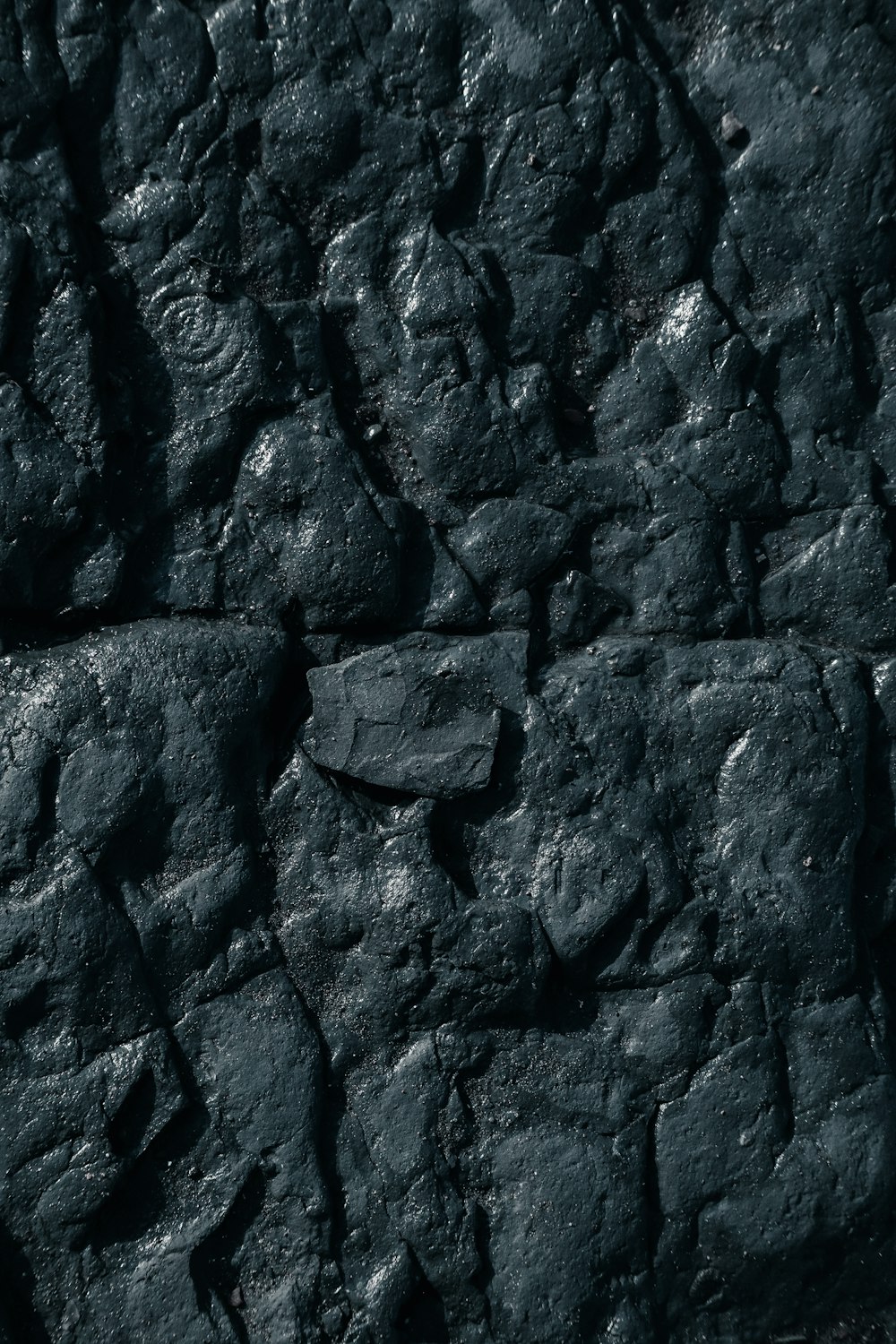 a close up of a black rock texture
