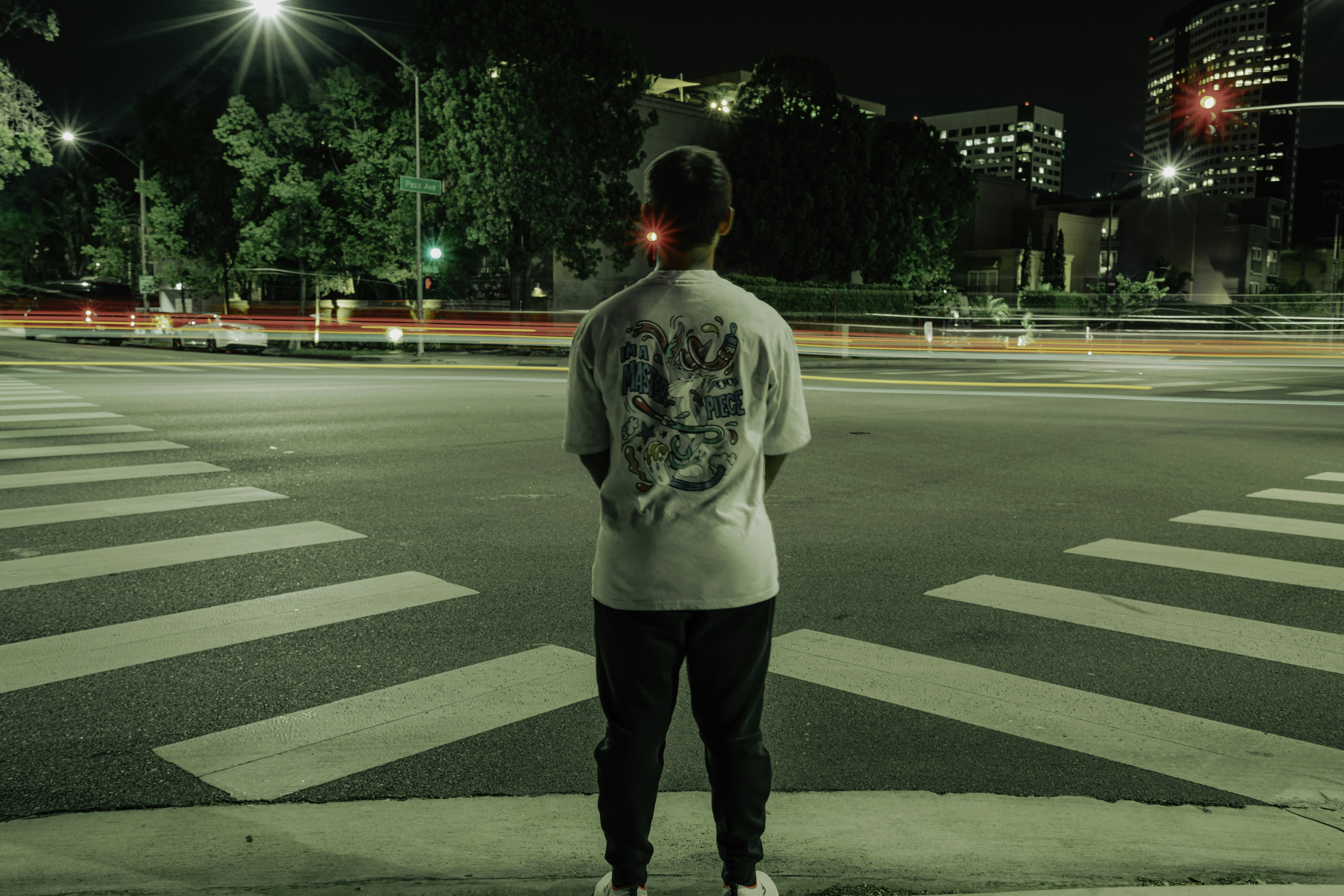 a man standing on the side of a road at night