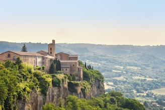 Orvieto Cathedral and medieval buildings atop volcanic cliffs in Italy.