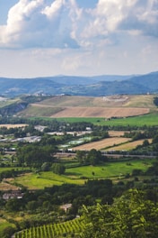 A scenic view of rural land with open fields and distant hills.