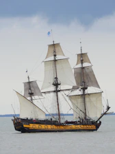 a large sailing ship in the middle of the ocean