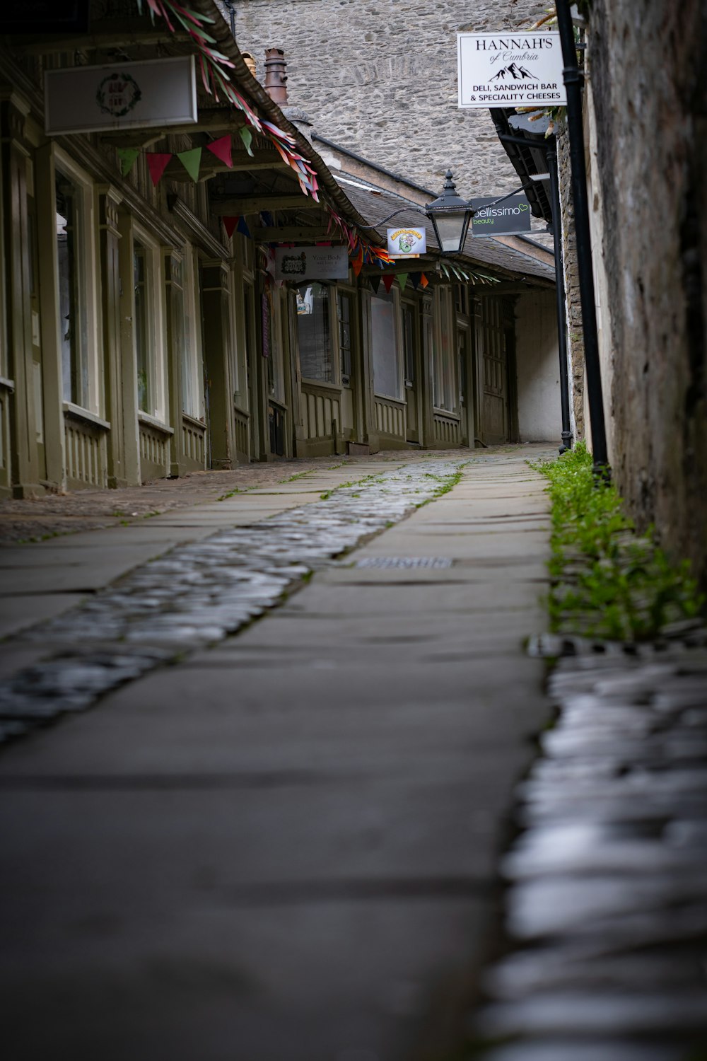 a narrow street with a sign on the side of it