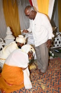 Elders blessing the couple with warm smiles and traditional attire.