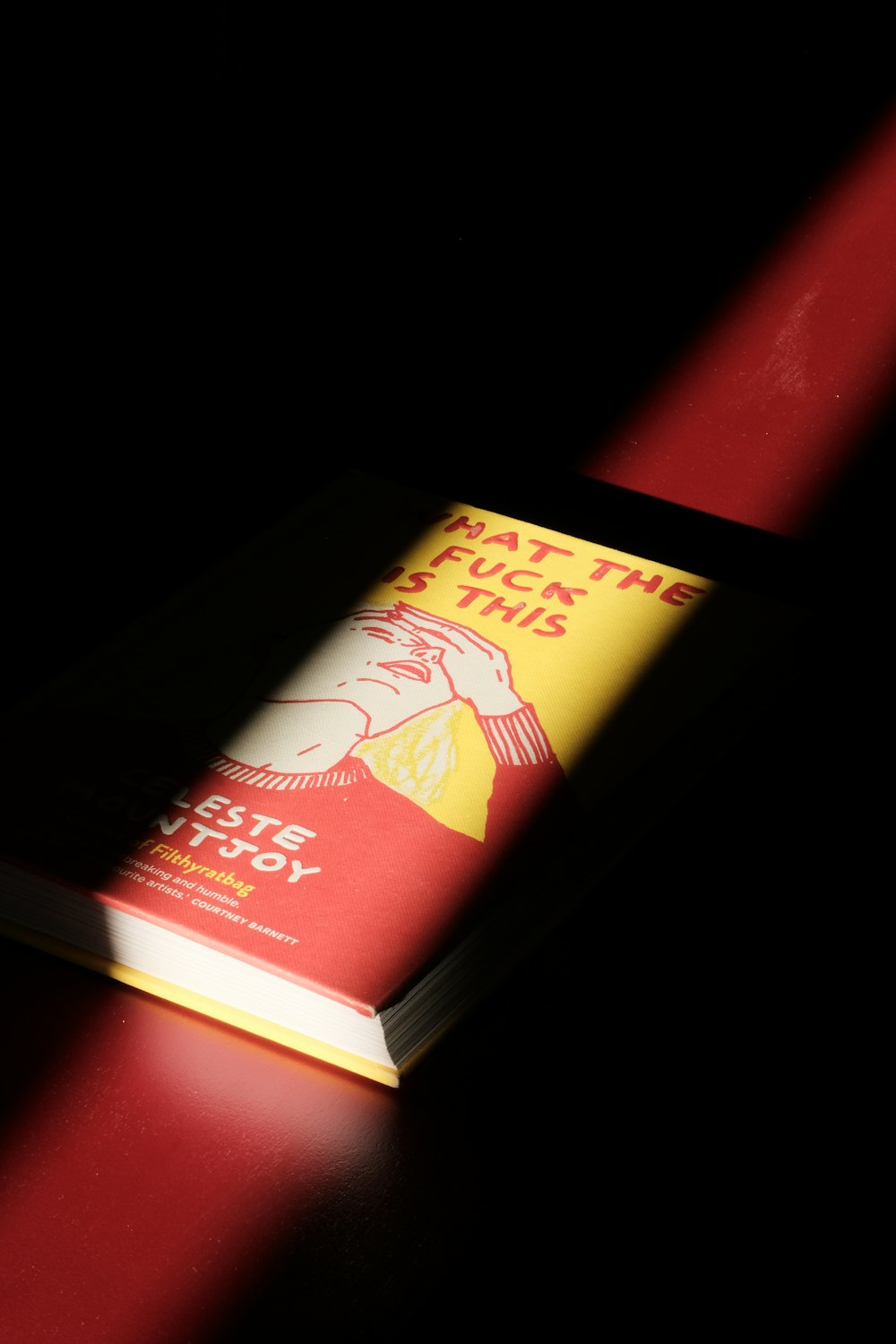 a book sitting on top of a red table