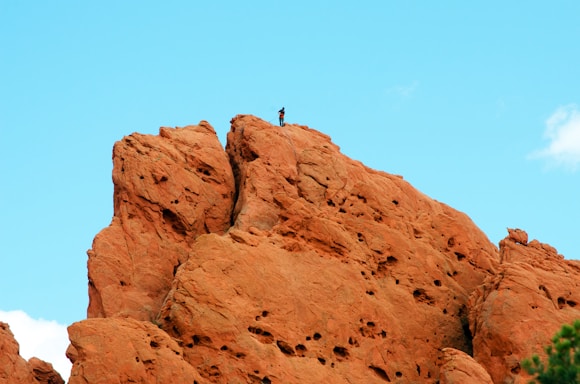 a person standing on top of a rock formation