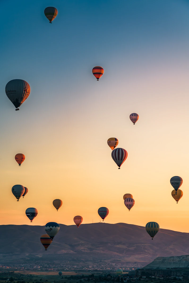 Hot air balloons flying over Cappadocia, Turkey at sunrise