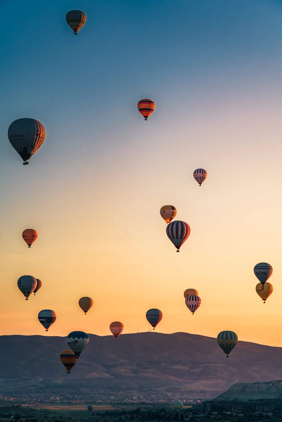 Hot air balloons flying over Cappadocia, Turkey at sunrise