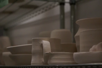 Colorful glazed pottery pieces cooling inside an electric kiln.