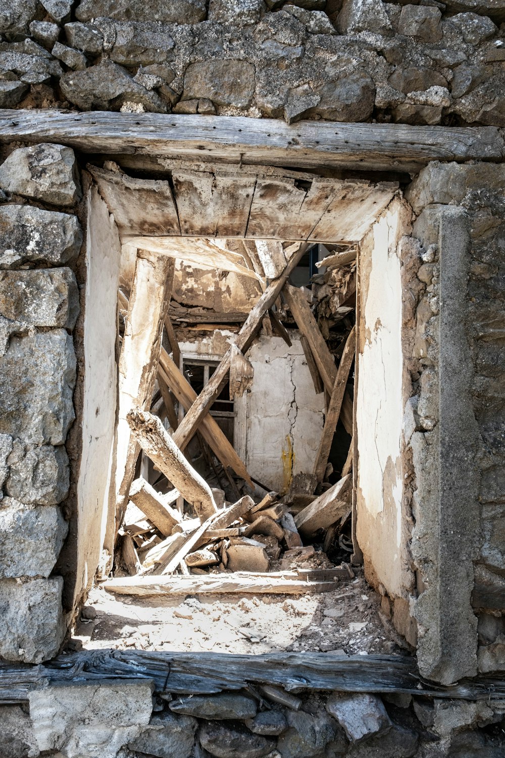 a broken down window in a stone wall