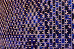 a blue and white tiled wall with white arrows