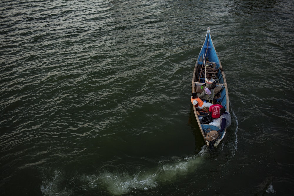 a small boat filled with people on a body of water