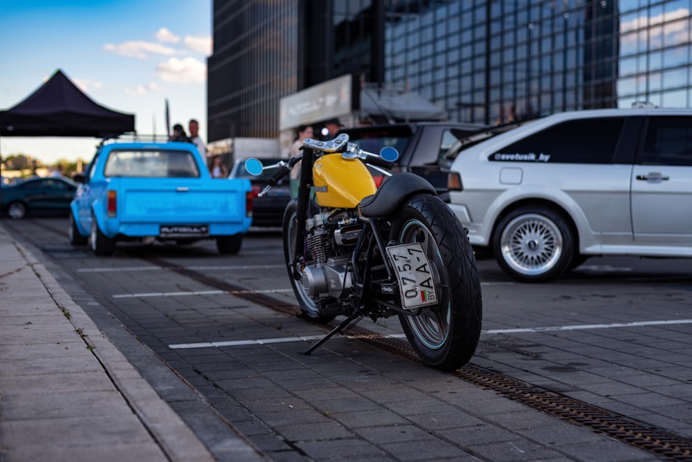 a yellow and black motorcycle parked in a parking lot