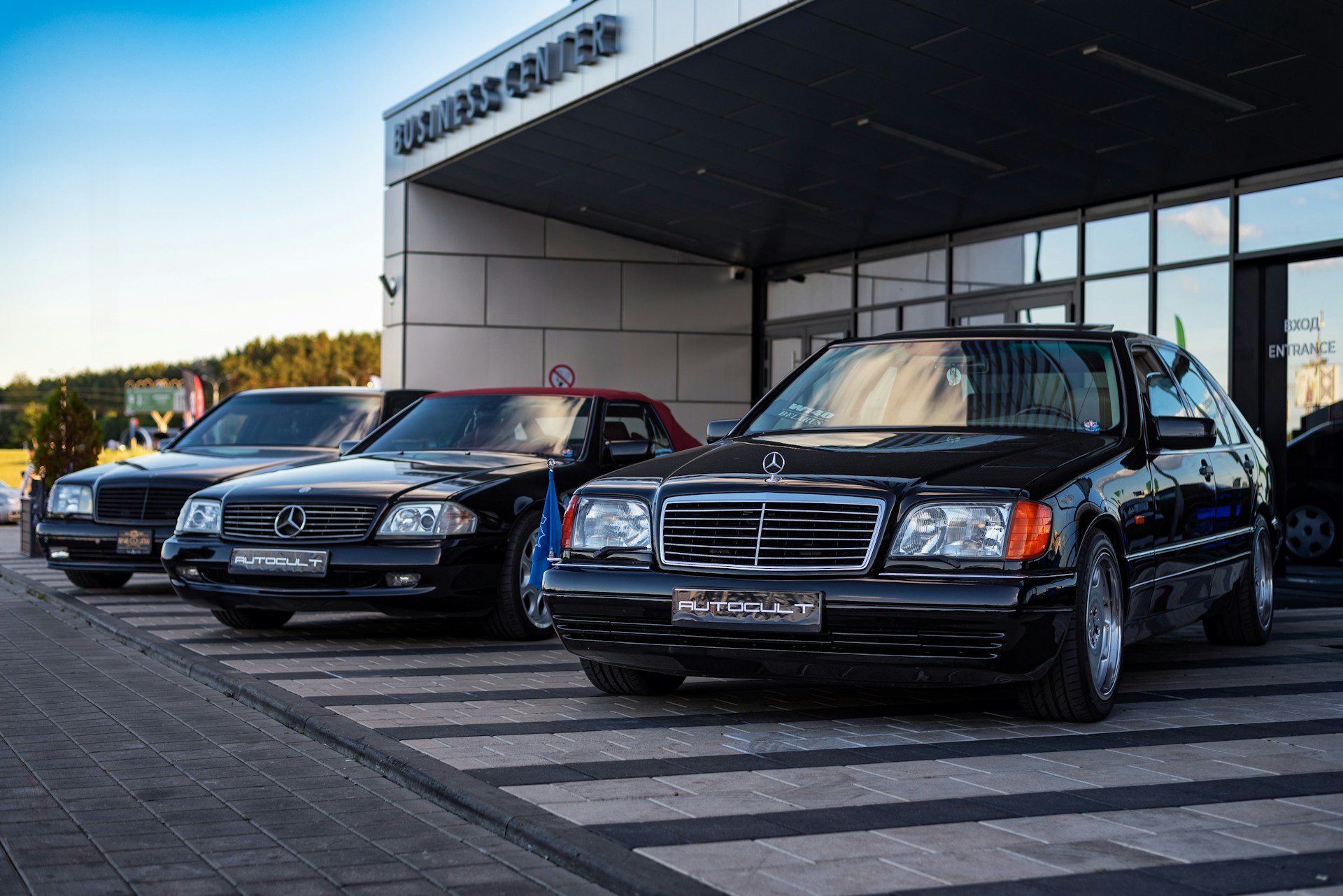 a row of parked cars in front of a building