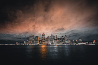 A sleek, dark city skyline at dusk, symbolizing power and ambition.