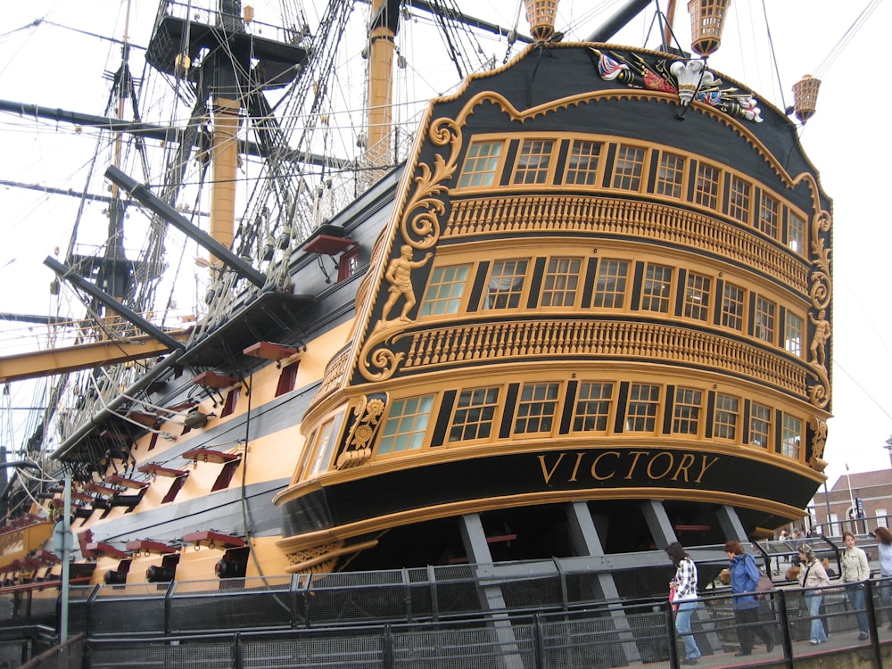 a replica of a large ship in a harbor