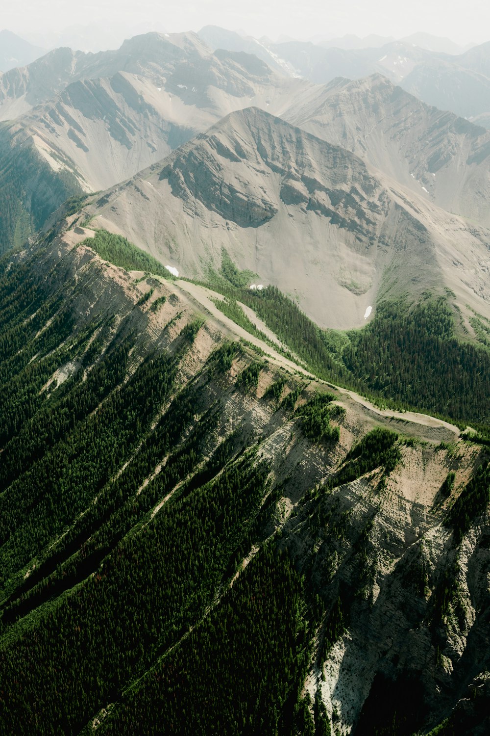 an aerial view of a mountain range with a road running through it