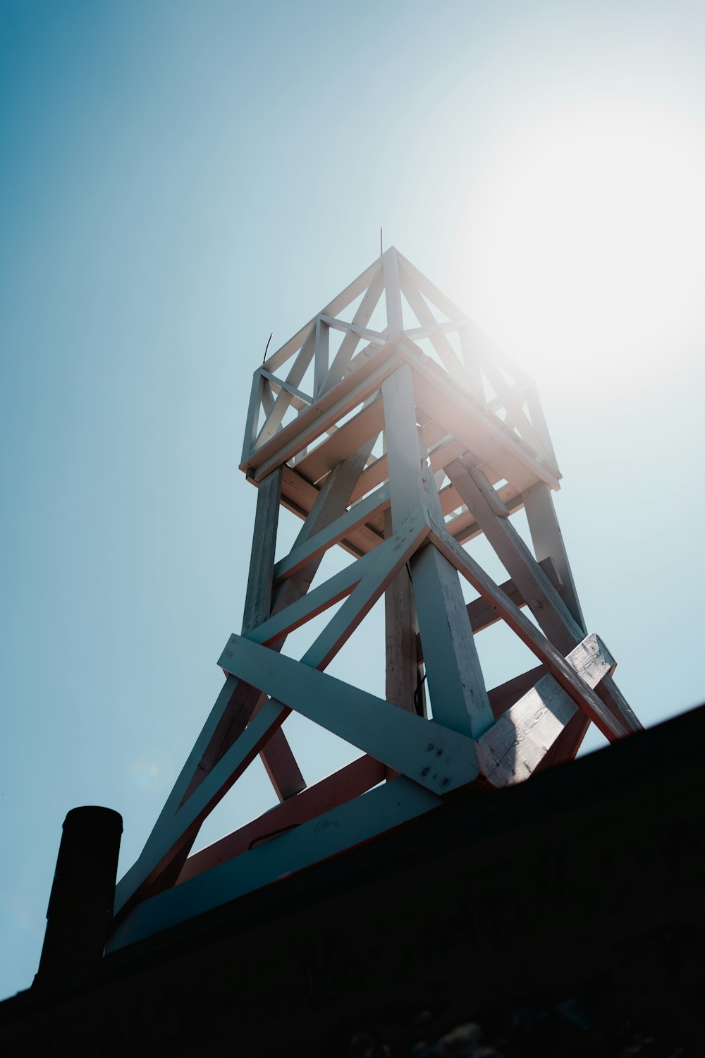 a tall wooden structure sitting on top of a roof