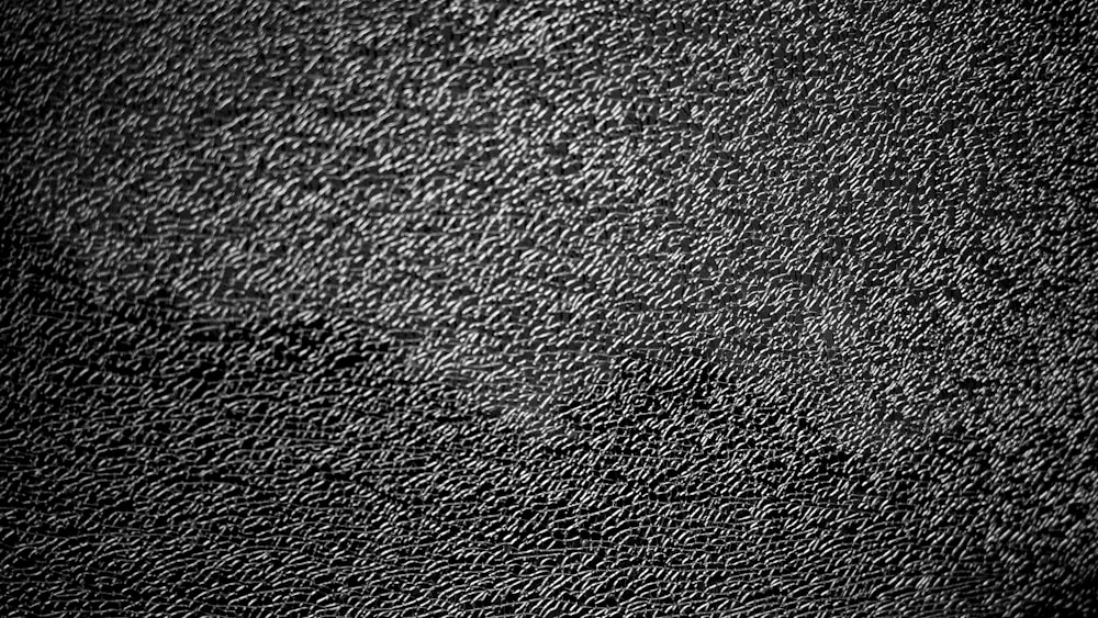 a black and white photo of a textured surface