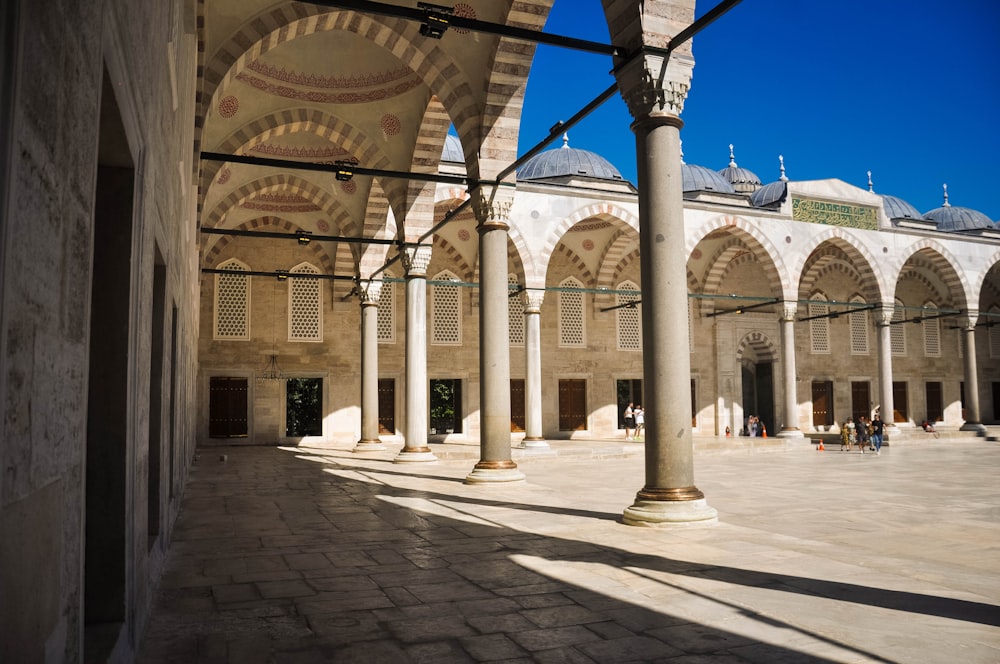 a large building with columns and arches in the middle of it