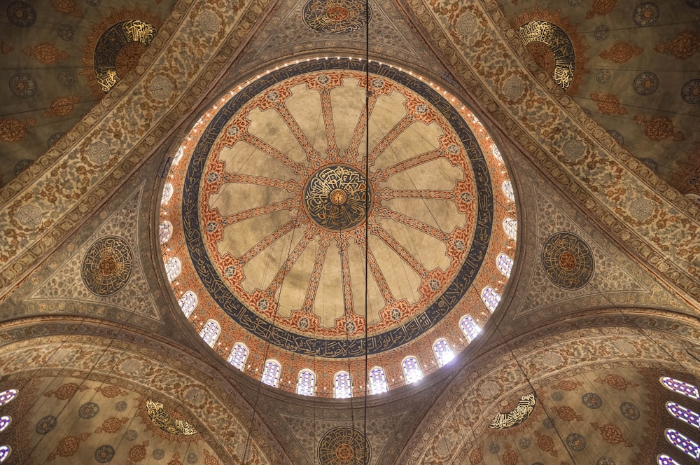 the ceiling of a large building with many windows