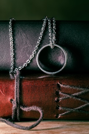 A graceful necklace draped over a vintage book, highlighting its fine finish.