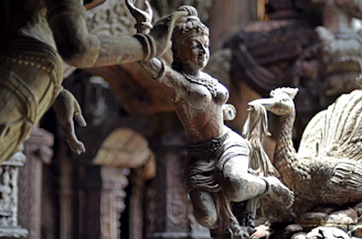 A wooden sculpture of a graceful dancer carved with delicate details