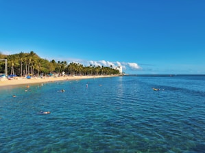 Tourists enjoying a scenic South Bali beach trip with clear blue skies and ocean.