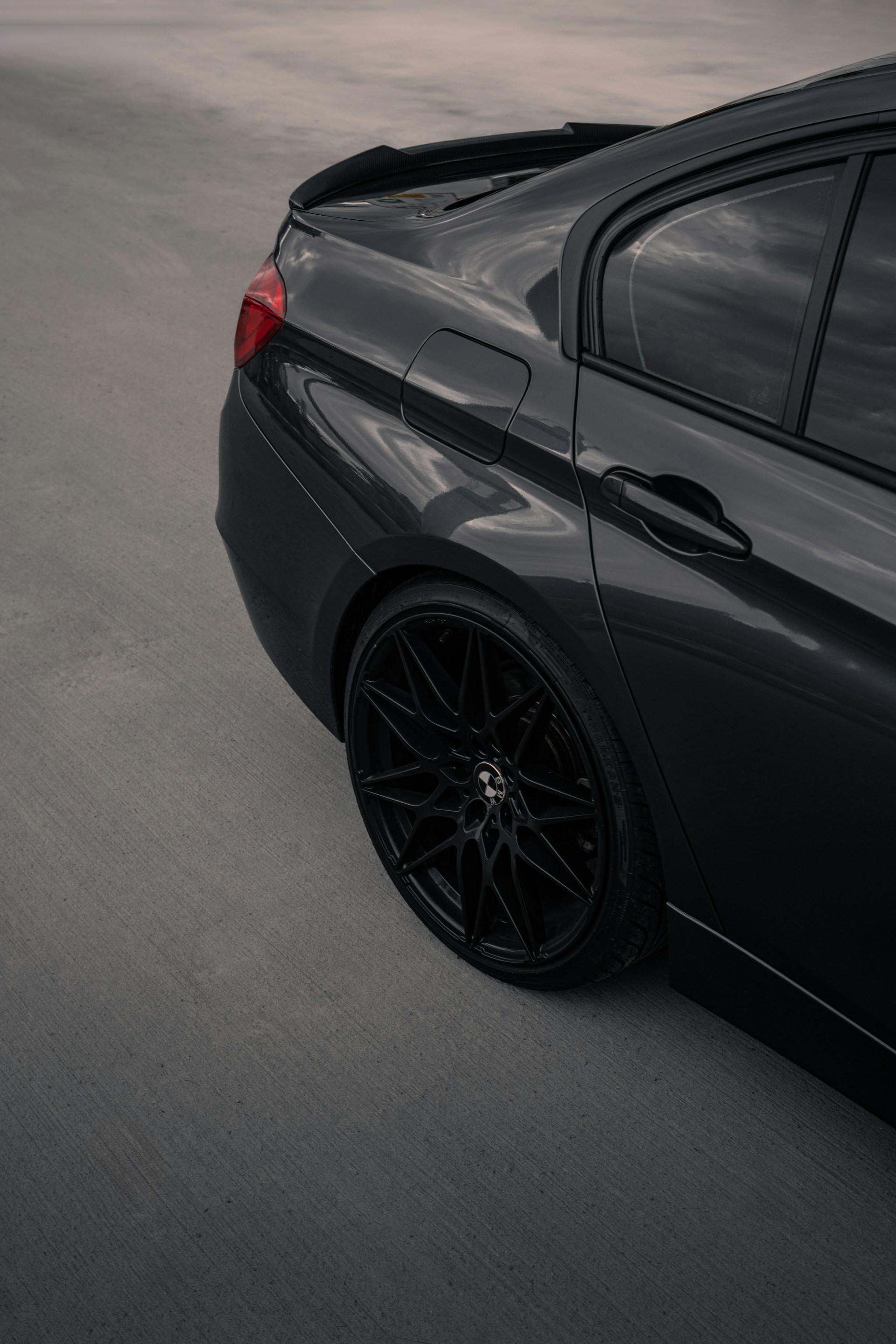 a close up of a black car on a road