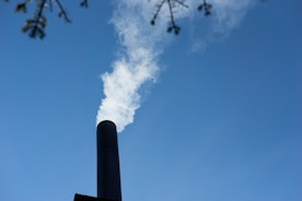 a smokestack emits from the top of a building