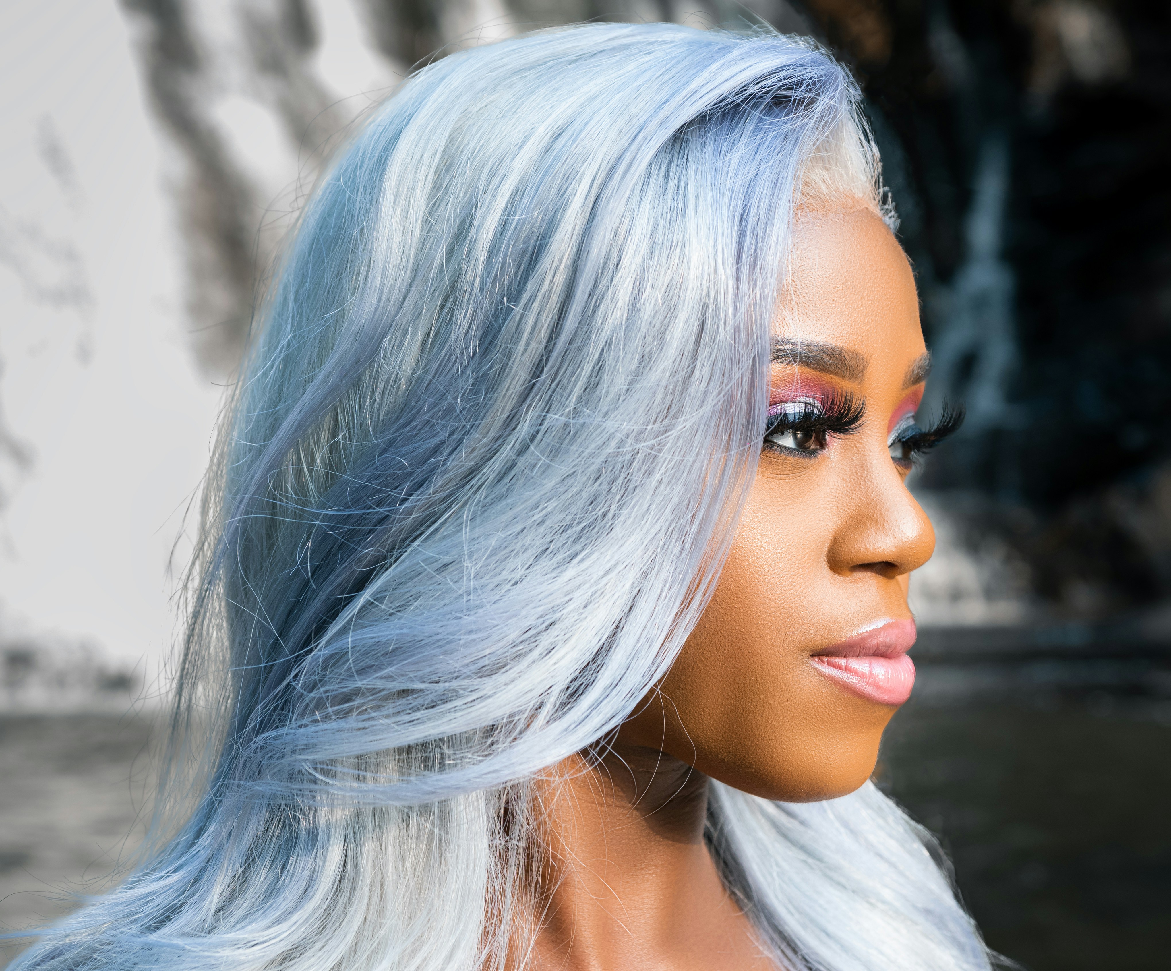 a close up of a person with long white hair