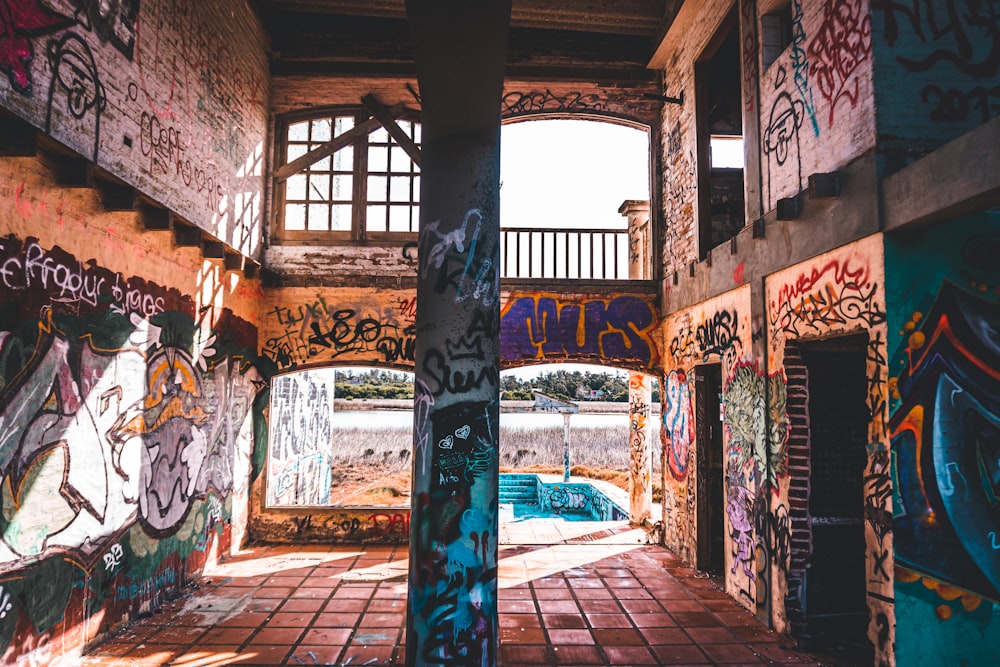 an abandoned building with graffiti all over the walls