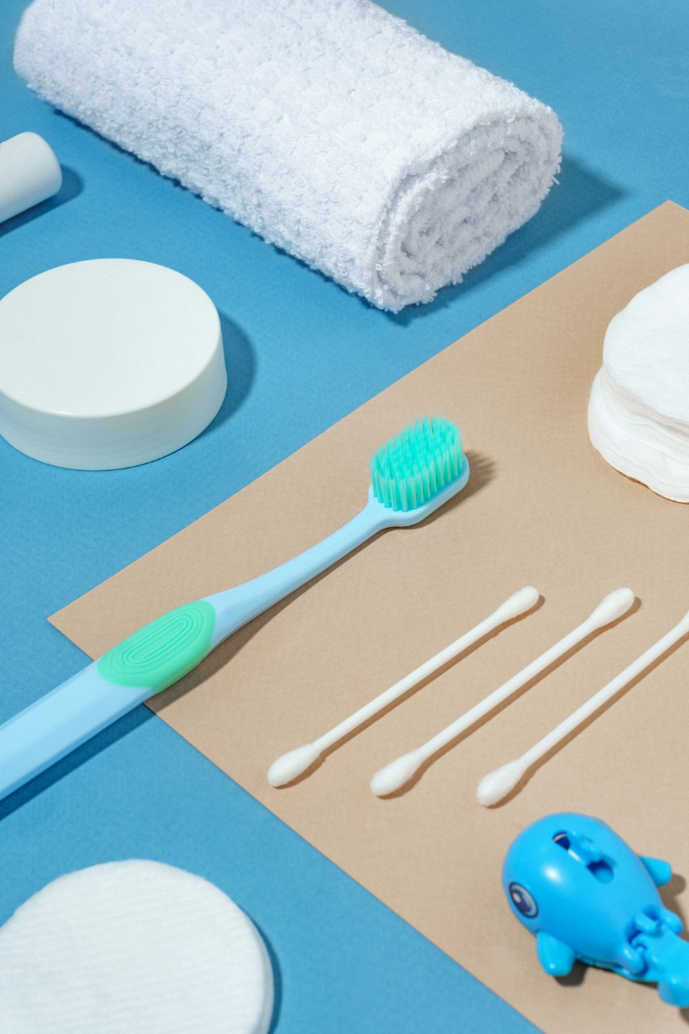 a blue toothbrush sitting on top of a piece of paper